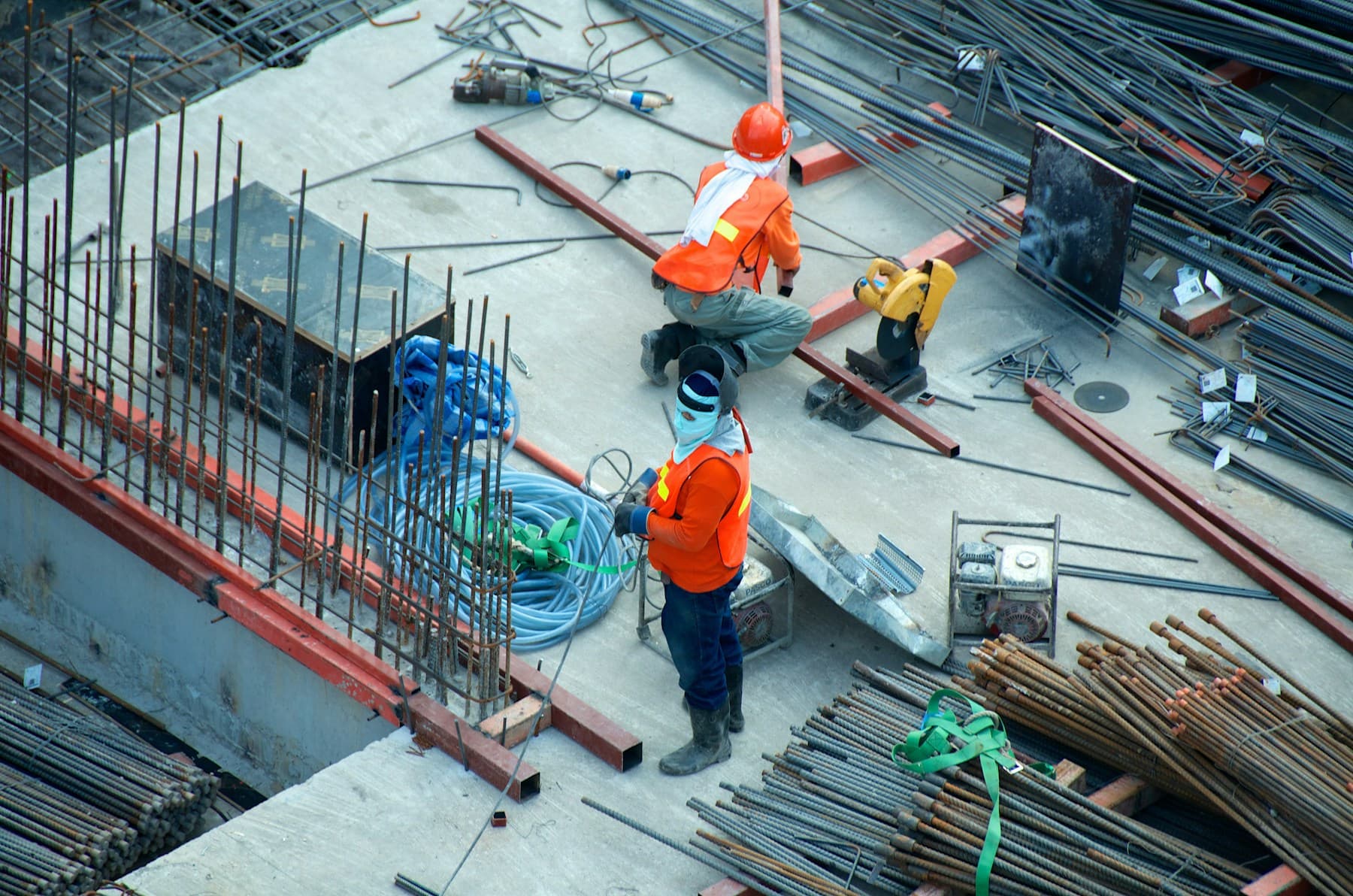 Construction professionals working with steel and concrete materials